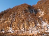 A mountain which covered with snow slightly